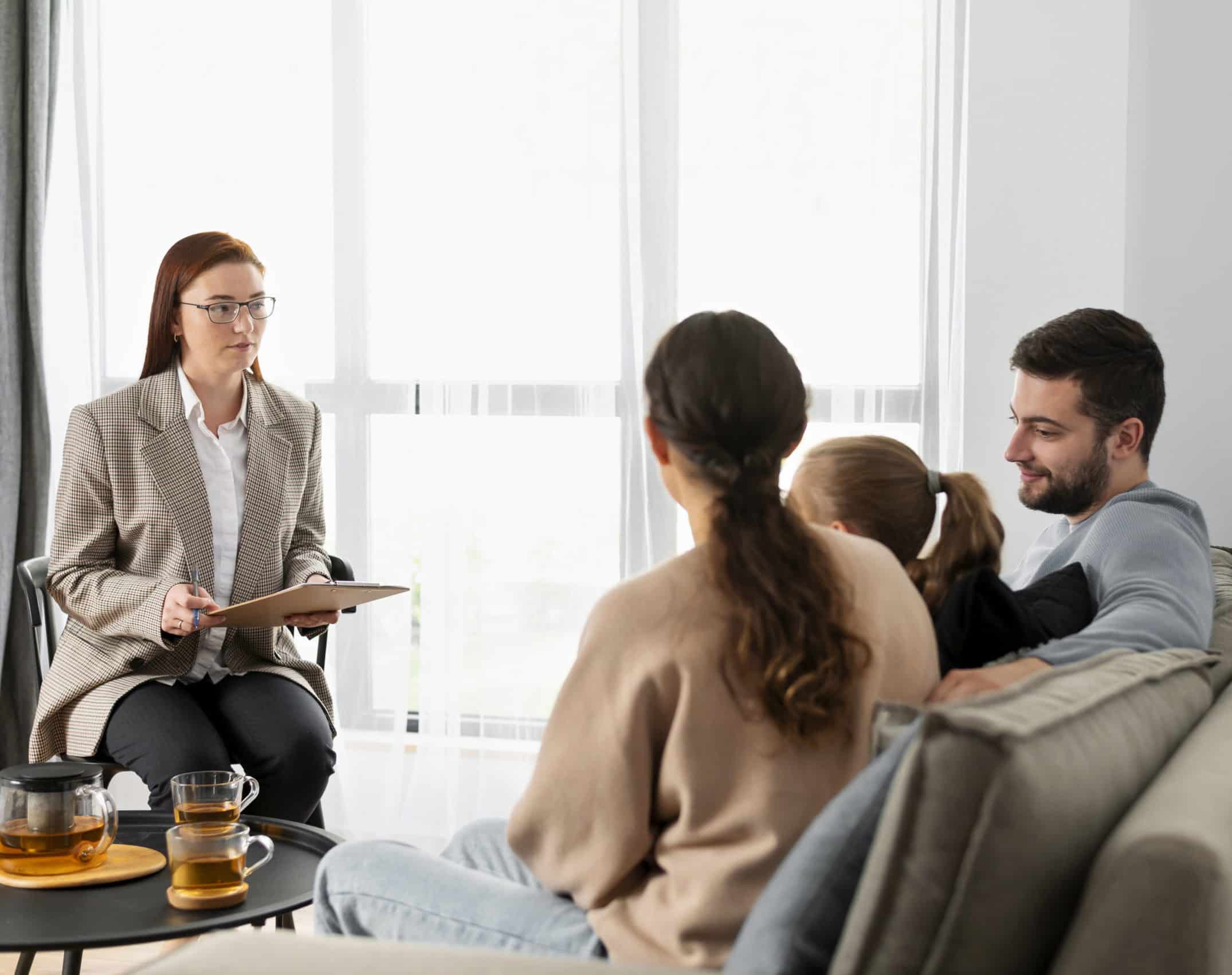 Medium shot family discussing with therapist